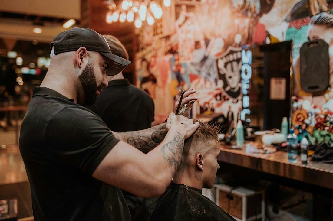 Barber shaping a client's hair with care